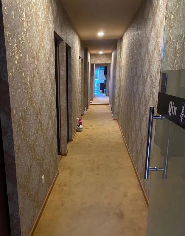 Softly lit hallway leading to private treatment rooms